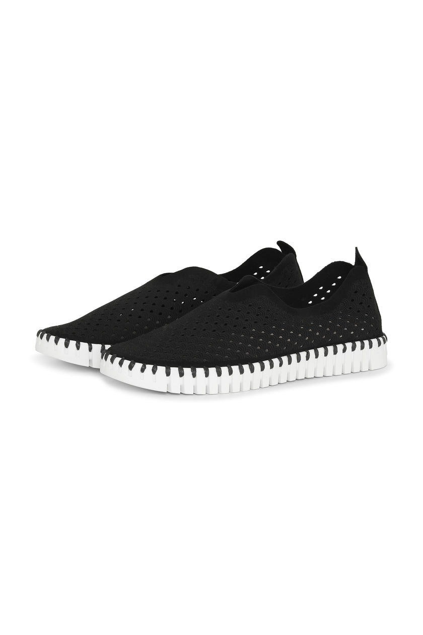 A pair of Black Ilse Jacobsen Tulip139 shoes with a laser cut pattern on the upper and a white sole.