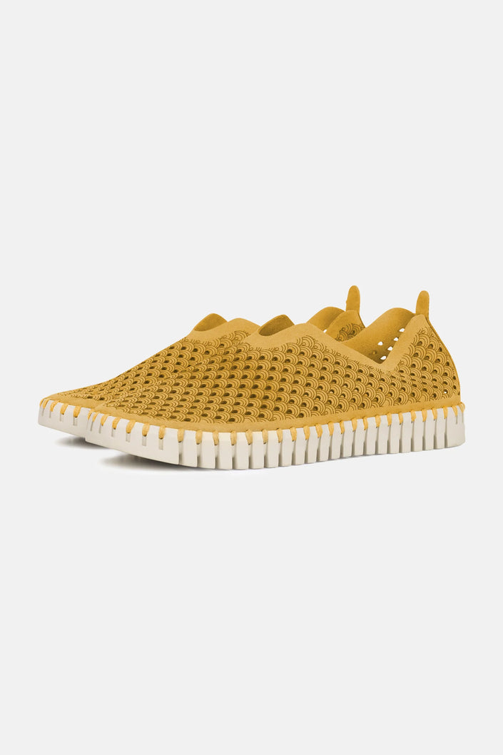A pair of Goldenrod Ilse Jacobsen Tulip139 shoes with a laser cut pattern on the upper and a white sole.