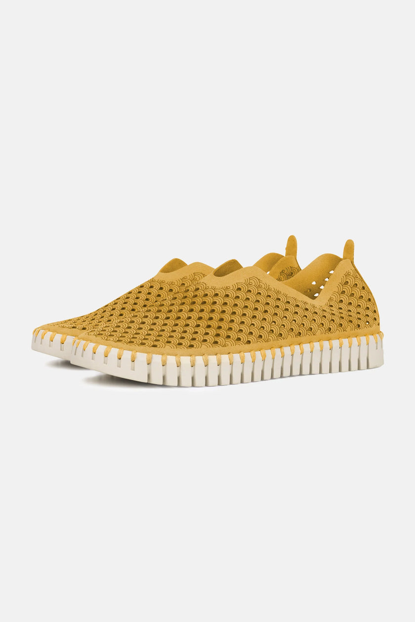 A pair of Goldenrod Ilse Jacobsen Tulip139 shoes with a laser cut pattern on the upper and a white sole.
