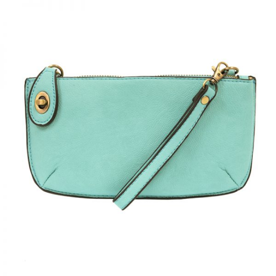 An aqua-colored mini crossbody wristlet clutch with brass plated hardware and a printed lining, displayed with the wristlet strap visible