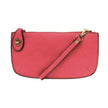 A begonia-colored mini crossbody wristlet clutch with brass plated hardware and a printed lining, displayed with the wristlet strap visible