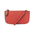 A berry-colored mini crossbody wristlet clutch with brass plated hardware and a printed lining, displayed with the wristlet strap visible