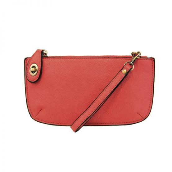 A berry-colored mini crossbody wristlet clutch with brass plated hardware and a printed lining, displayed with the wristlet strap visible