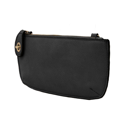 A black-colored mini crossbody wristlet clutch with brass plated hardware and a printed lining, displayed without straps
