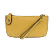 A butter-colored mini crossbody wristlet clutch with brass plated hardware and a printed lining, displayed with the wristlet strap visible