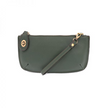A chive-colored mini crossbody wristlet clutch with brass plated hardware and a printed lining, displayed with the wristlet strap visible