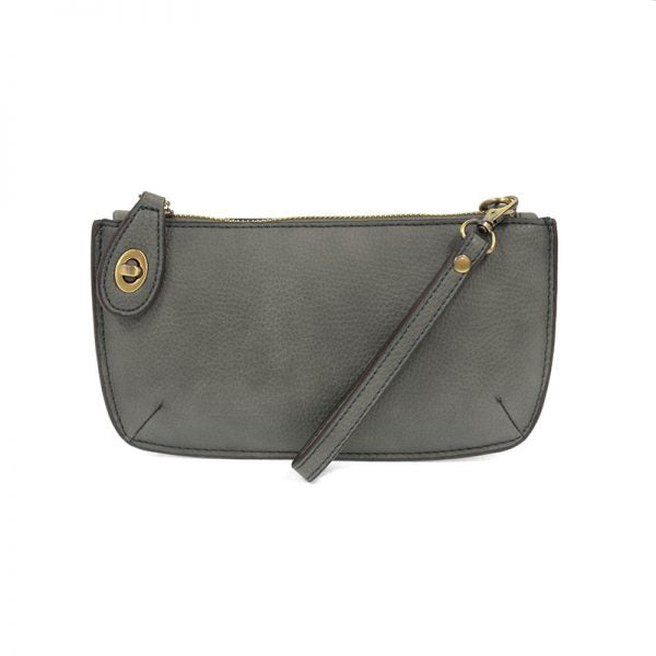 A cloudy sky-colored mini crossbody wristlet clutch with brass plated hardware and a printed lining, displayed with the wristlet strap visible