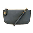 A dark chambray-colored mini crossbody wristlet clutch with brass plated hardware and a printed lining, displayed with the wristlet strap visible