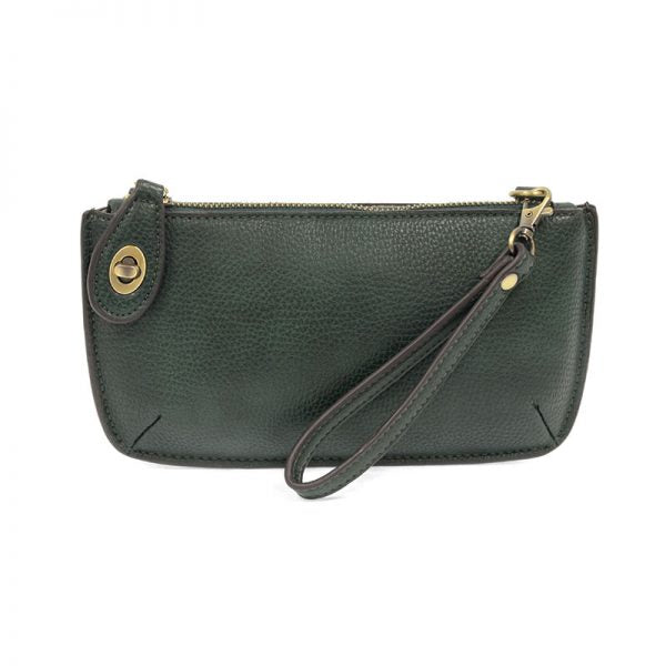 A green opal-colored mini crossbody wristlet clutch with brass plated hardware and a printed lining, displayed with the wristlet strap visible