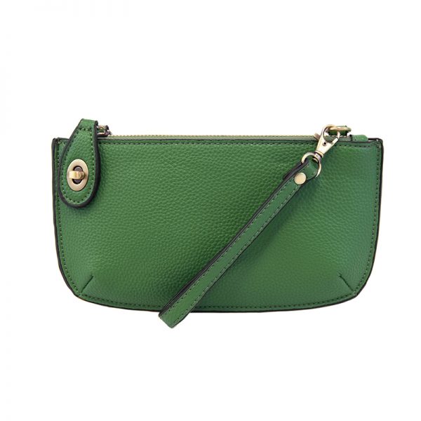 A kelly-colored mini crossbody wristlet clutch with brass plated hardware and a printed lining, displayed with the wristlet strap visible