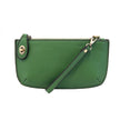 A kelly-colored mini crossbody wristlet clutch with brass plated hardware and a printed lining, displayed with the wristlet strap visible