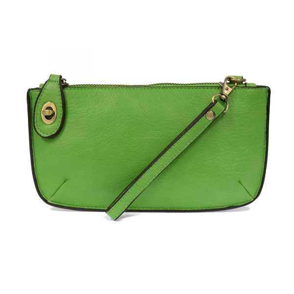 A key lime-colored mini crossbody wristlet clutch with brass plated hardware and a printed lining, displayed with the wristlet strap visible