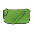 A key lime-colored mini crossbody wristlet clutch with brass plated hardware and a printed lining, displayed with the wristlet strap visible