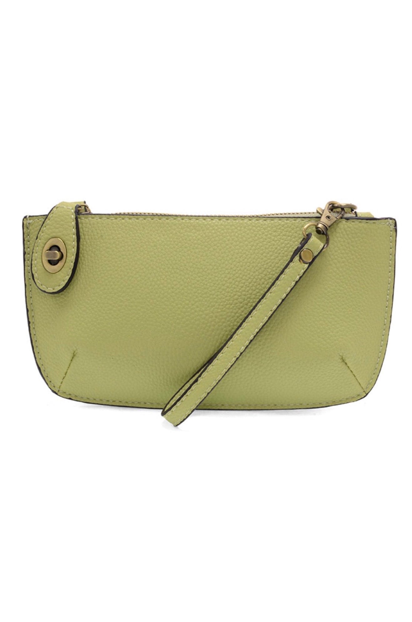 A kiwi-colored mini crossbody wristlet clutch with brass plated hardware and a printed lining, displayed with the wristlet strap visible