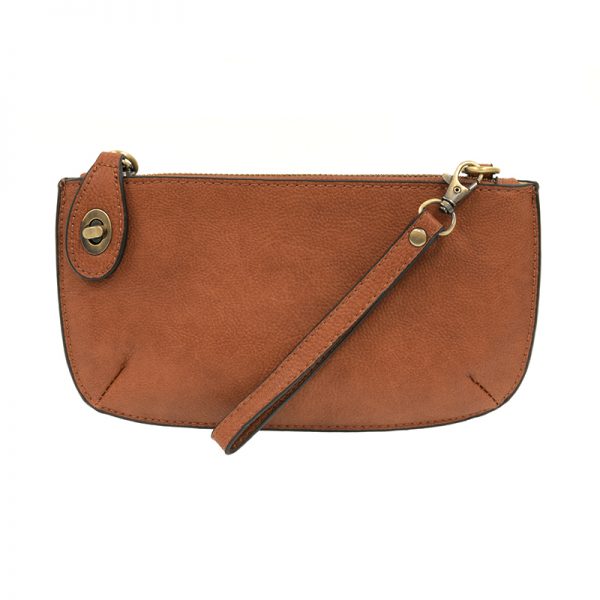 A maple-colored mini crossbody wristlet clutch with brass plated hardware and a printed lining, displayed with the wristlet strap visible