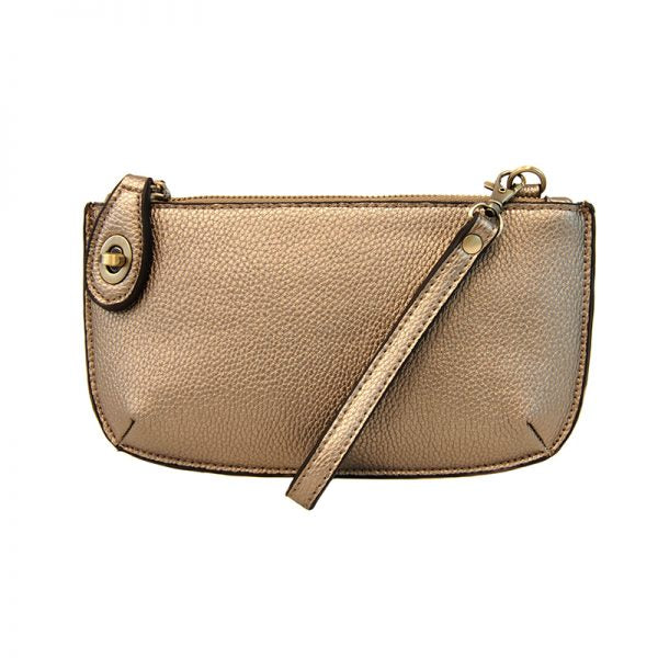 A metallic light bronze-colored mini crossbody wristlet clutch with brass plated hardware and a printed lining, displayed with the wristlet strap visible