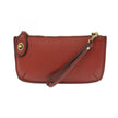 A garnet-colored mini crossbody wristlet clutch with brass plated hardware and a printed lining, displayed with the wristlet strap visible