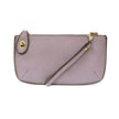 A wisteria-colored mini crossbody wristlet clutch with brass plated hardware and a printed lining, displayed with the wristlet strap visible