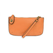 An orange sherbert-colored mini crossbody wristlet clutch with brass plated hardware and a printed lining, displayed with the wristlet strap visible