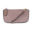 A petunia purple-colored mini crossbody wristlet clutch with brass plated hardware and a printed lining, displayed with the wristlet strap visible