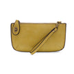 A shortbread yellow-colored mini crossbody wristlet clutch with brass plated hardware and a printed lining, displayed with the wristlet strap visible