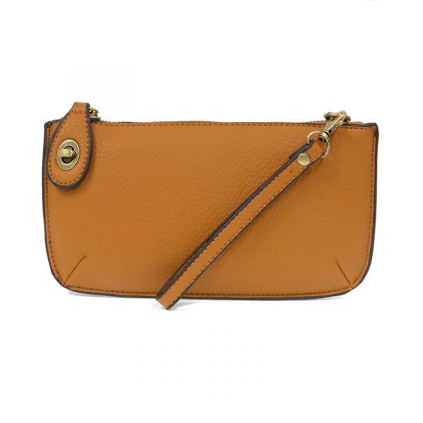 A sienna-colored mini crossbody wristlet clutch with brass plated hardware and a printed lining, displayed with the wristlet strap visible