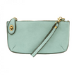 A sky blue-colored mini crossbody wristlet clutch with brass plated hardware and a printed lining, displayed with the wristlet strap visible