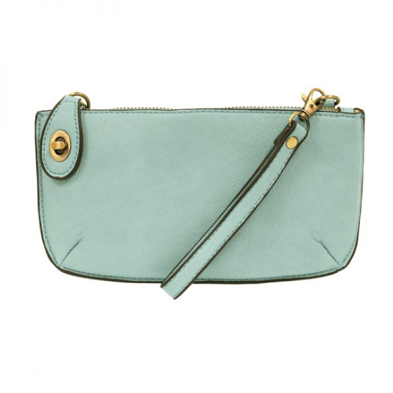 A sky blue-colored mini crossbody wristlet clutch with brass plated hardware and a printed lining, displayed with the wristlet strap visible