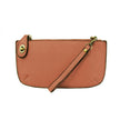 A sunset-colored mini crossbody wristlet clutch with brass plated hardware and a printed lining, displayed with the wristlet strap visible