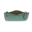 A ultramarine-colored mini crossbody wristlet clutch with brass plated hardware and a printed lining, internal view