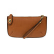 A whiskey-colored mini crossbody wristlet clutch with brass plated hardware and a printed lining, displayed with the wristlet strap visible