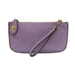 A wild orchid-colored mini crossbody wristlet clutch with brass plated hardware and a printed lining, displayed with the wristlet strap visible