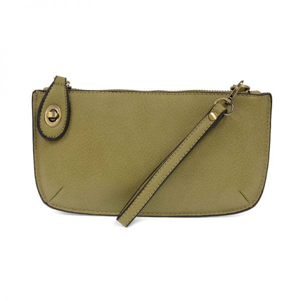 A willow green-colored mini crossbody wristlet clutch with brass plated hardware and a printed lining, displayed with the wristlet strap visible