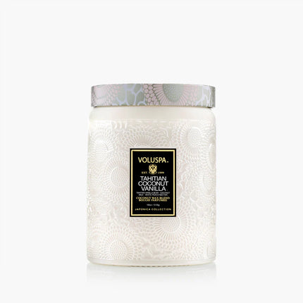 White textured candle with Voluspa label on a white background