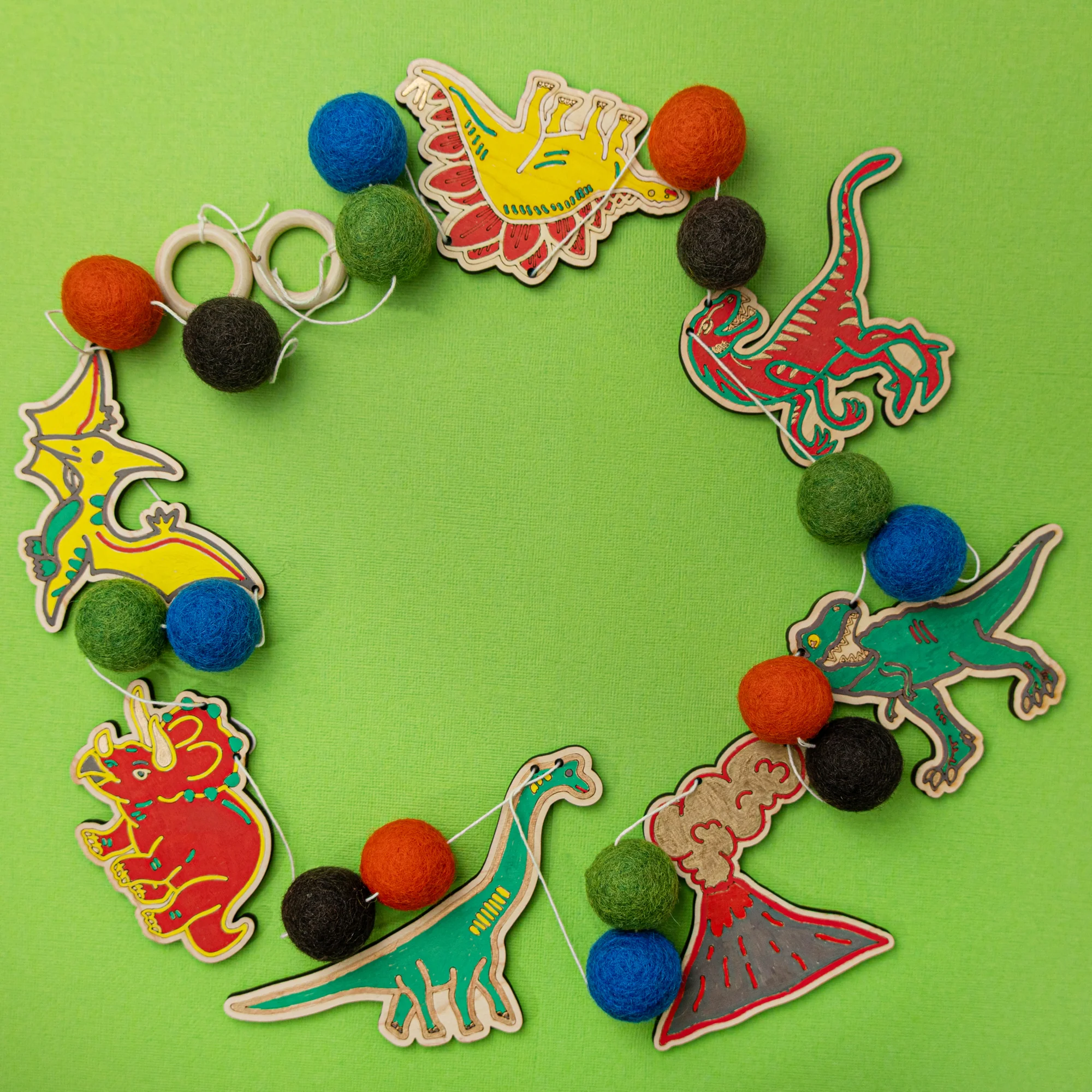 Do It Yourself Wood Garland dinosaurs colored in