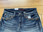 Grace denim stud and butterfly embroidered short-front pocket detail