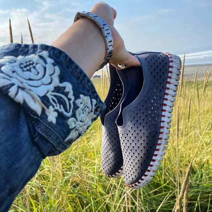 A pair of the Rachelle M Exclusive colorway Beachwalker Ilse Jacobsen Tulip139 shoes with a laser cut pattern on the upper and a white sole.