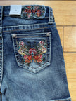 Grace denim stud and butterfly embroidered short-back pocket detail