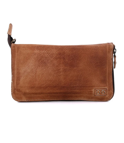 The Bed|Stu Templeton ii Clutch Wallet is a brown, vegetable tanned leather zippered wallet featuring visible natural texture and a small stitched logo in the bottom right corner.