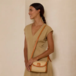 Brown Rattan Clutch with Leather Trim and Crossbody Strap-detail for scale